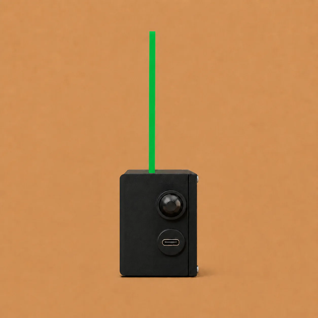 Constian sign glowing green, seen from the side with its button and USB-C port